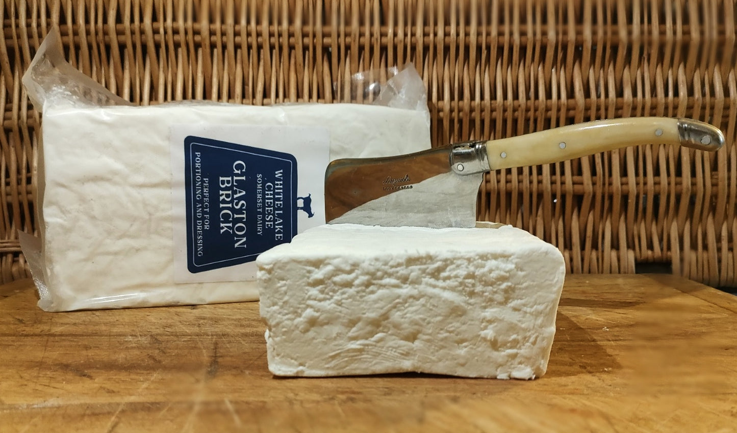 Tasty Somerset, creamy cheese, positioned on wooden cheese board. Ready to eat!